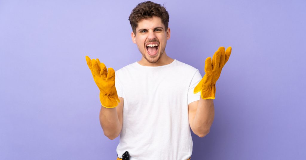 Young electrician man over isolated on purple background unhappy and frustrated with something
