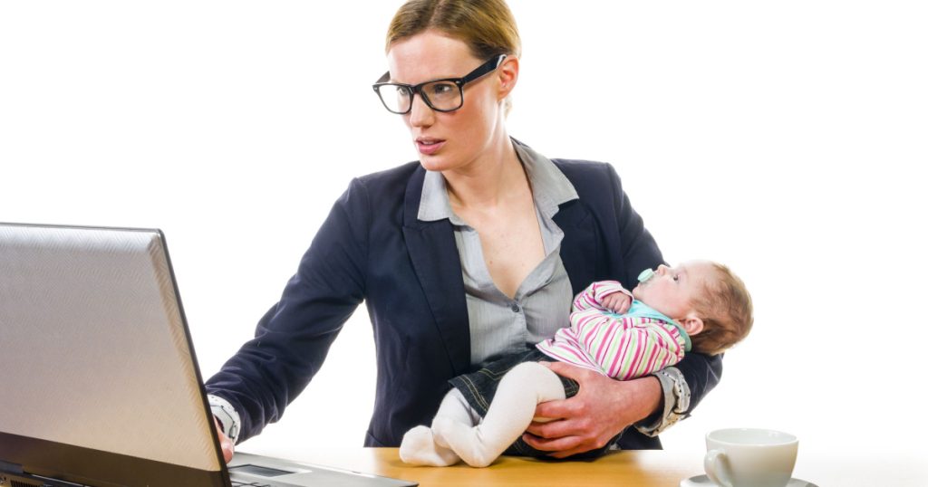 Adult business woman wearing a costume and supplied her newborn daughter in the office workplace, isolated against a white background.
