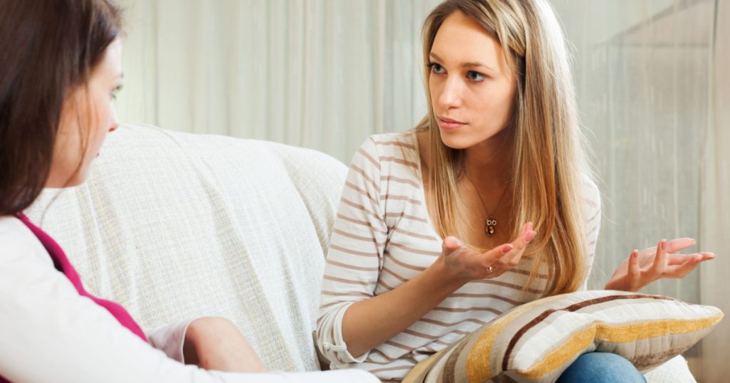 woman telling to friend about her problems in home
