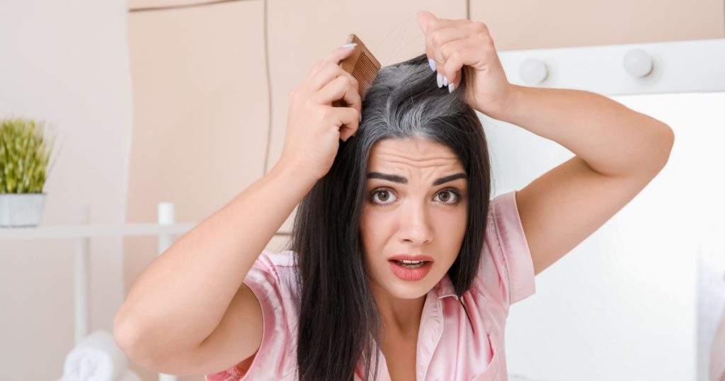 Stressed woman with graying hair at home
