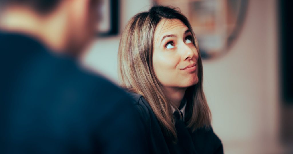 Funny Woman Feeling Bored Talking to her Boyfriend. Wife rolling her eyes at her husband arguments