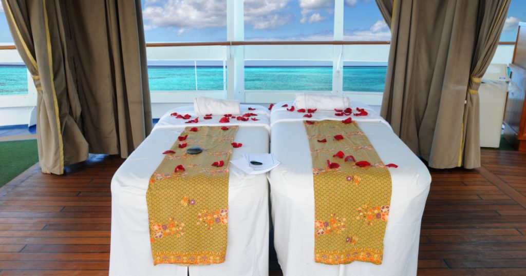 Massage beds with beautiful tropical beach in background
