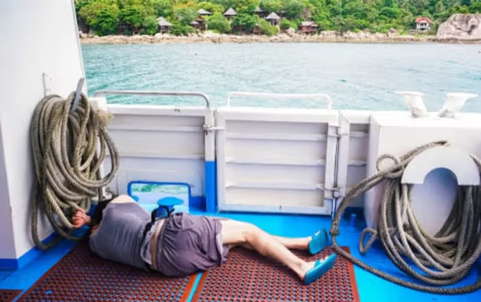 man lying on boat