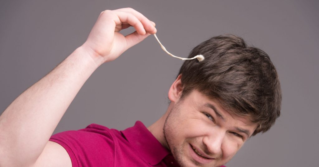 Portrait of man with chewing gum in his hair