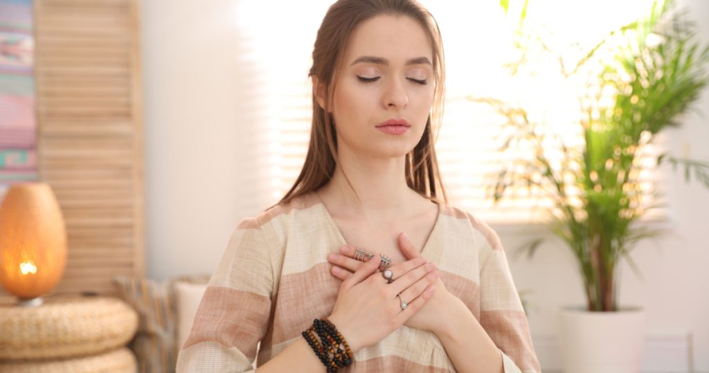 Young woman during self-healing session in therapy room
