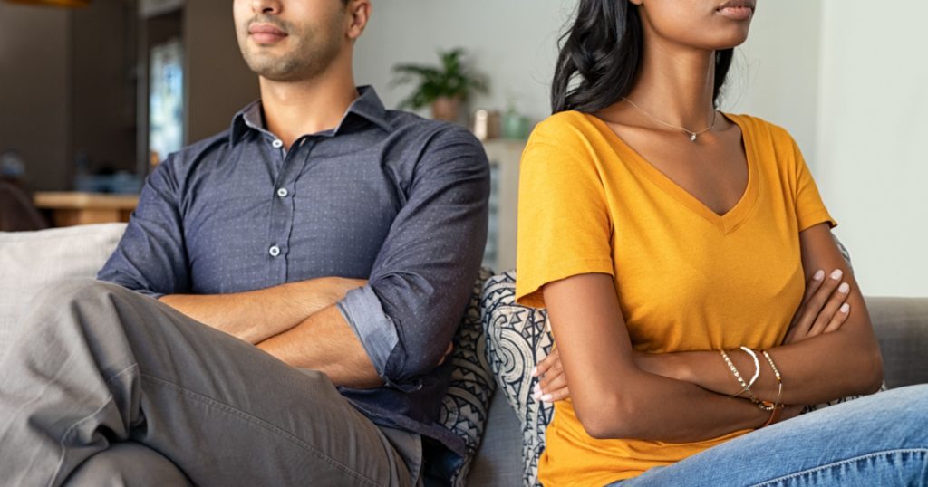 couple upset not facing eachother arms crossed