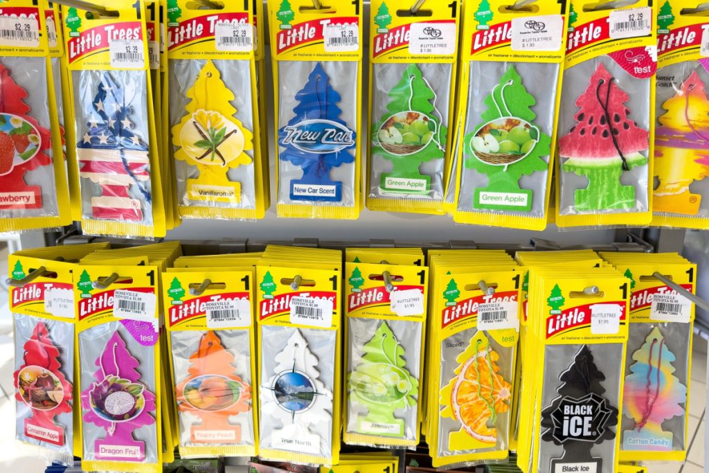 Little Trees car air fresheners on a stand in the middle of a store.