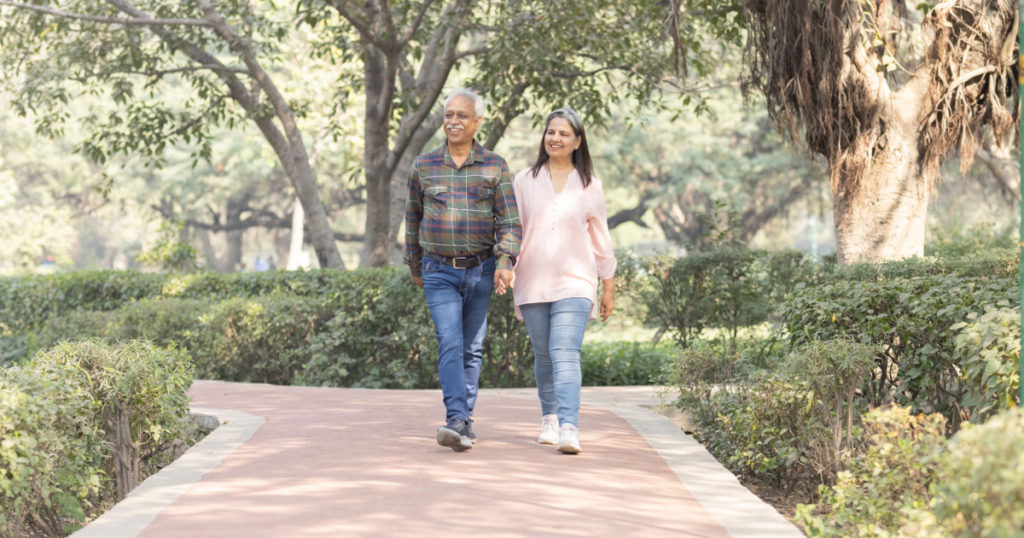 Happy senior couple spending leisure time in park during weekend
