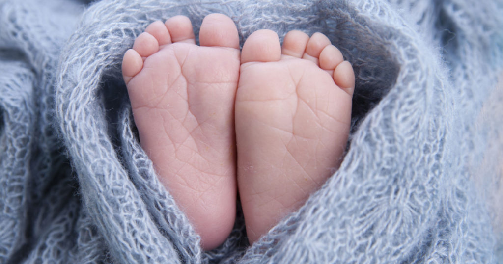 tiny foot of newborn baby
