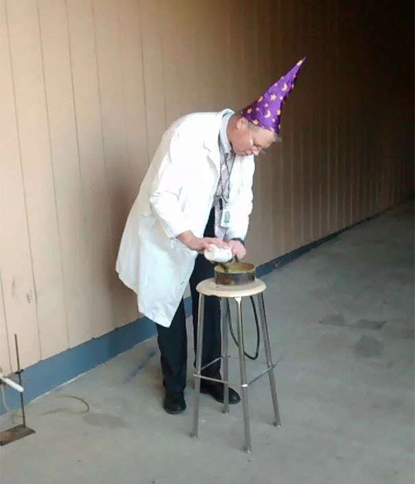 Physics teacher doing experiments with wizard hat