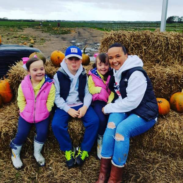 Twins with Down Syndrome and family at pumpkin patch