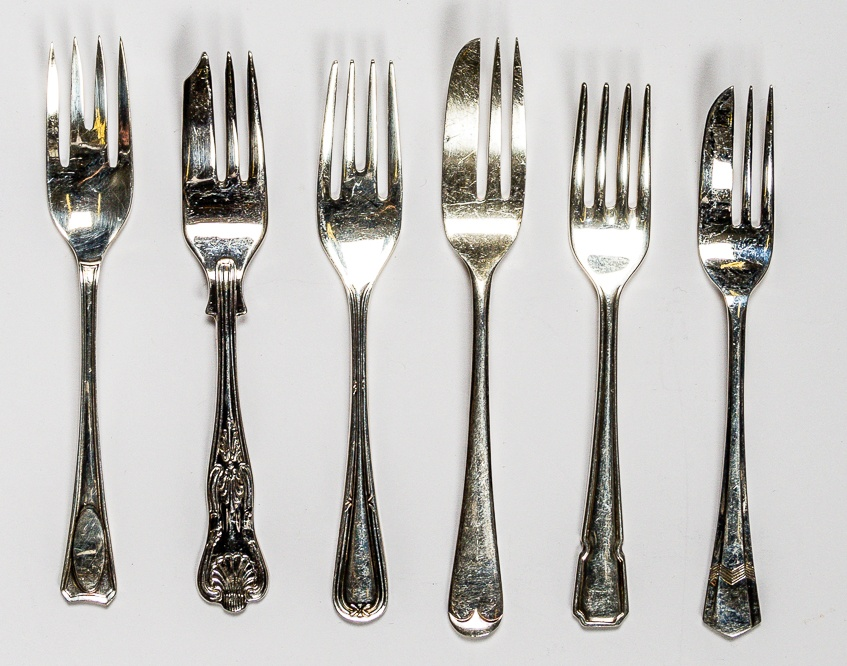 A variety of silver cake forks
