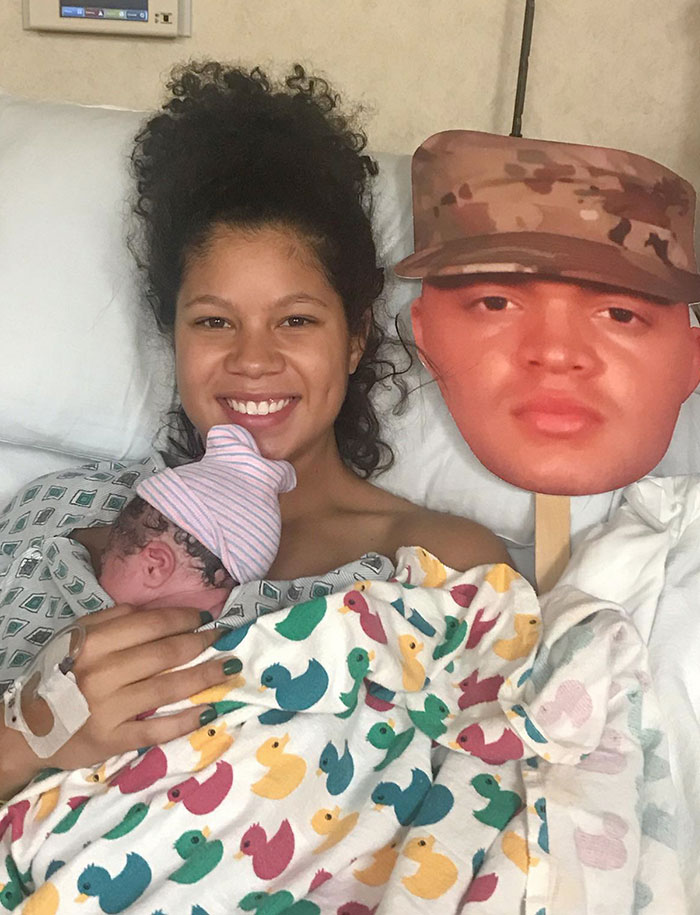Wife with baby in hospital bed with husband's face as a cutout