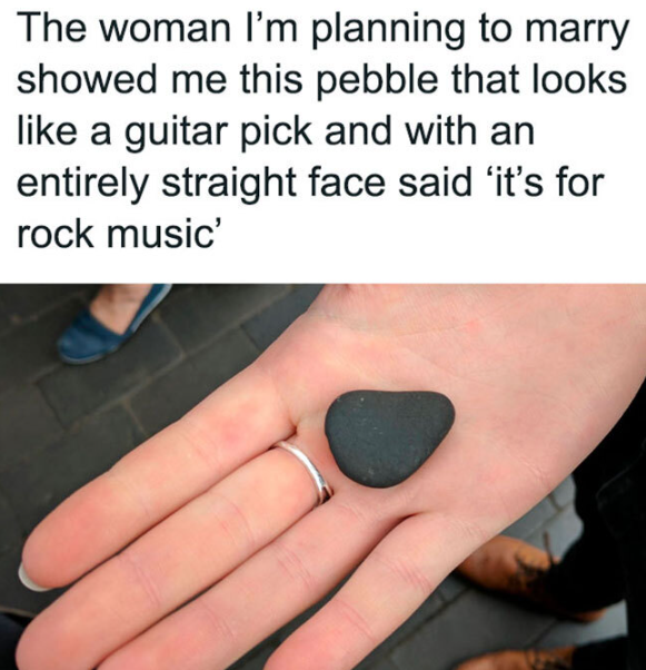holding a pebble shaped as a guitar pick
