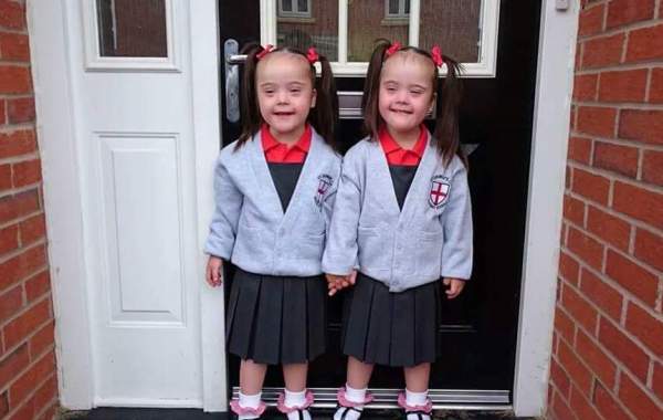 Twins take a picture in their school uniform