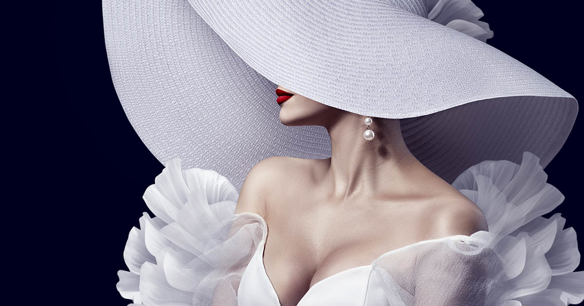 woman in white cocktail dress type outfit with large white hat