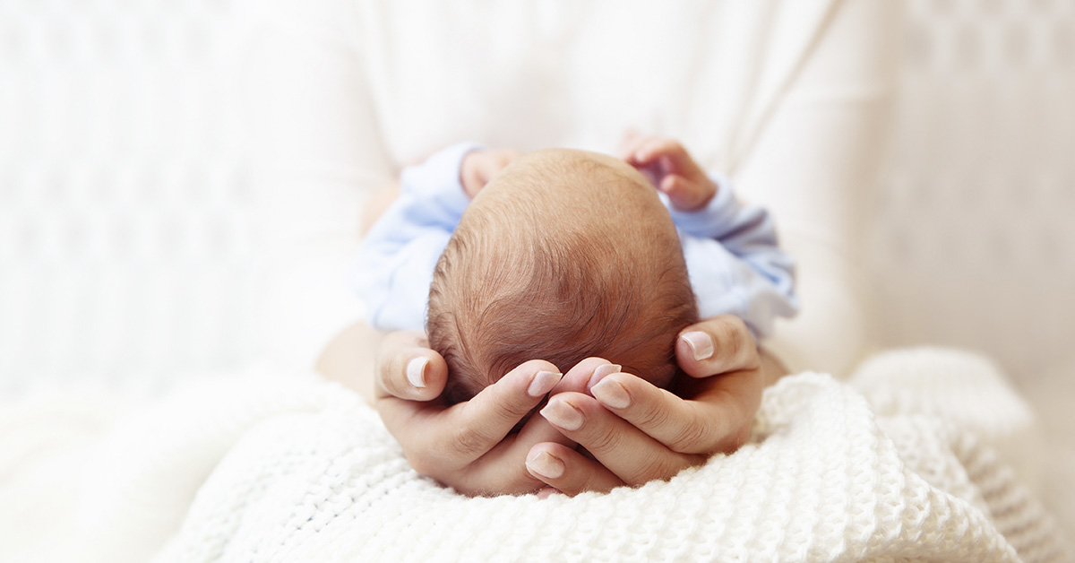 infant in hands of person