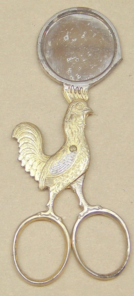 Vintage kitchen tool from 1850 with rooster design.