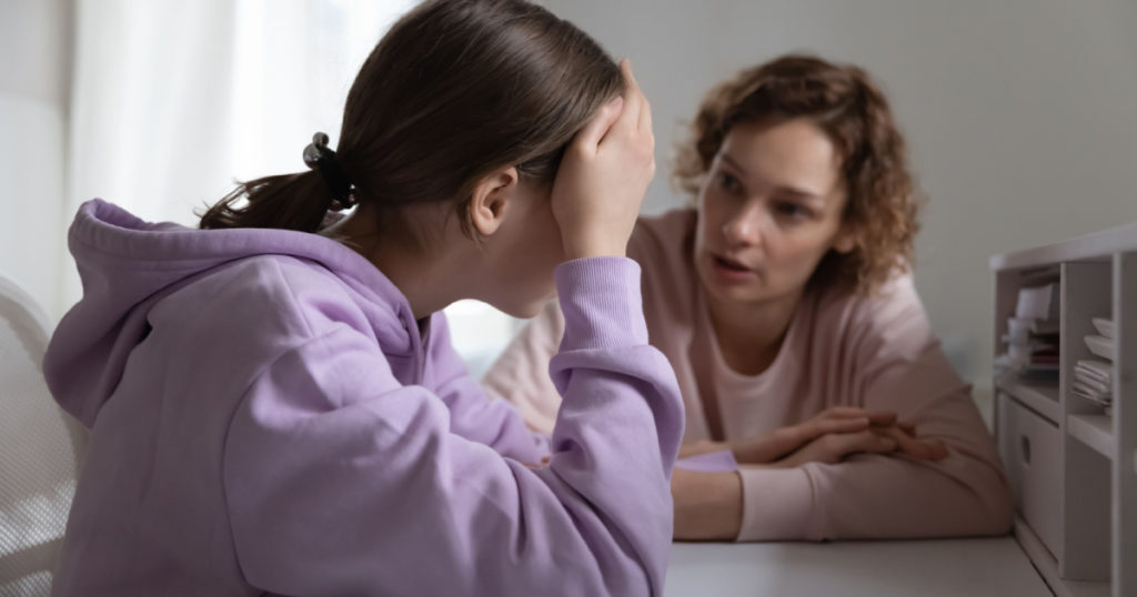 Strict mother scolding upset depressed teenage daughter for bad marks or school exam results, angry mum lecturing lazy unmotivated teen girl, generations, parent and child conflict
