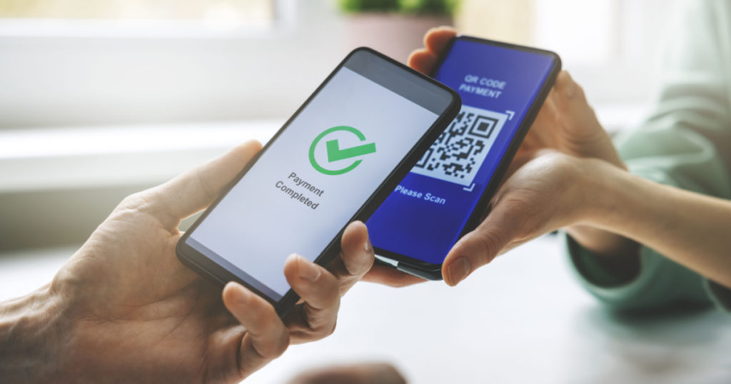 qr code payment - person paying with mobile phone
