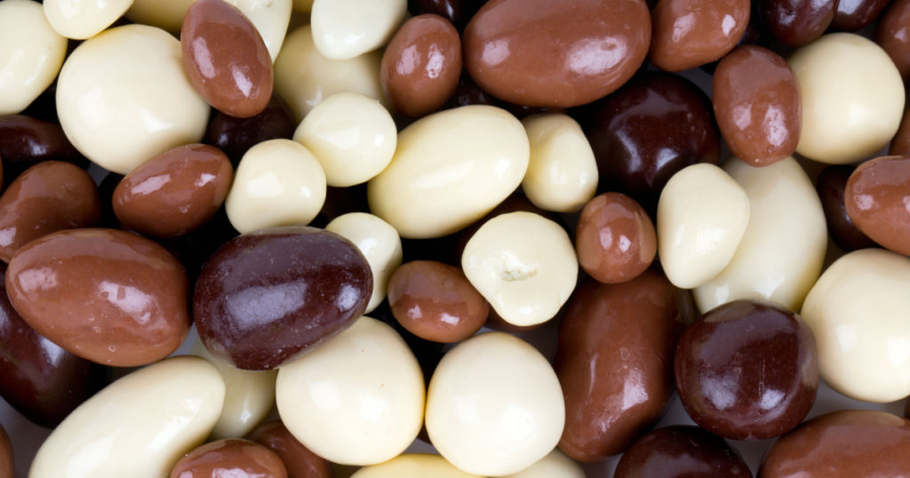 chocolate covered nuts and raisins background

