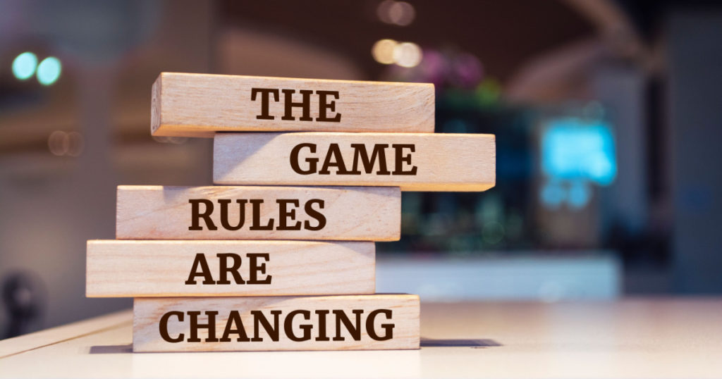 Wooden blocks with words 'The Game Rules Are Changing'.
