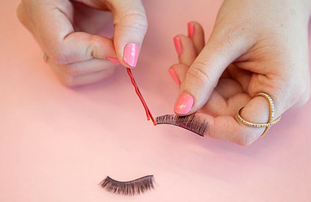 a handy beauty hack involves using one end of a bobby pin to apply the glue onto the lash strip.