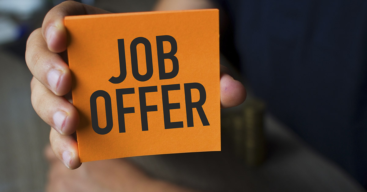 someone holding orange card that reads "Job Offer"