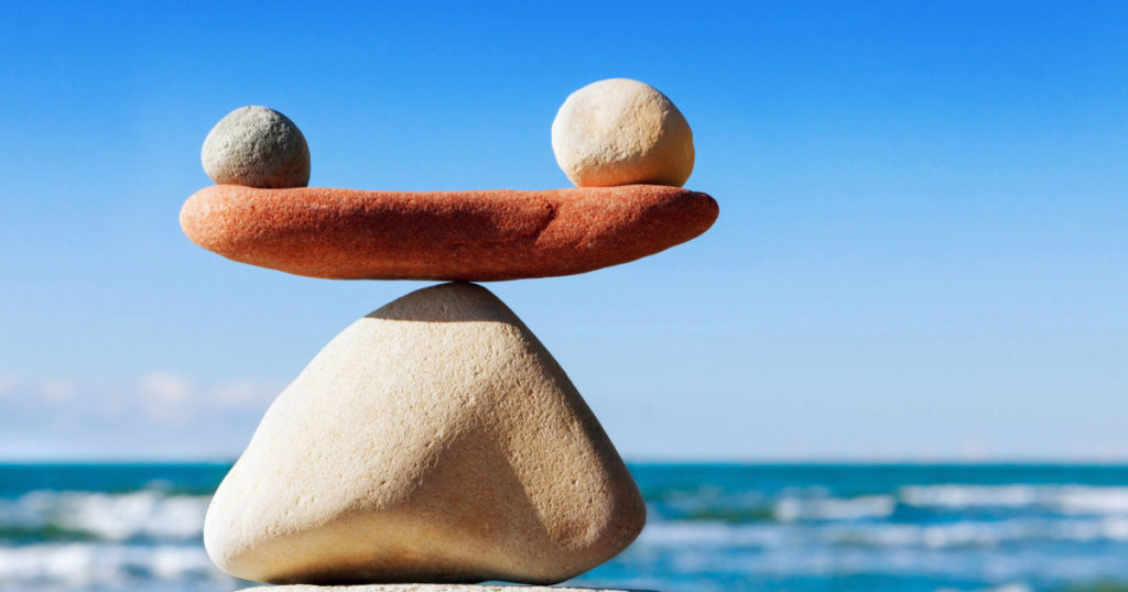 Concept of harmony and balance. Balance stones against the sea. Rock zen in the form of scales
