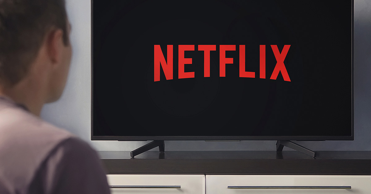 person watching TV with the Netflix logo on it