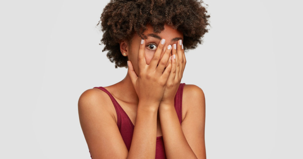 shy woman coveriing face hiding secret things