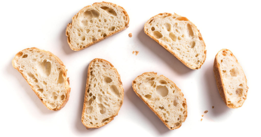 Fresh homebaked artisan sourdough bread. Slices of bread isolated on white background, design element.