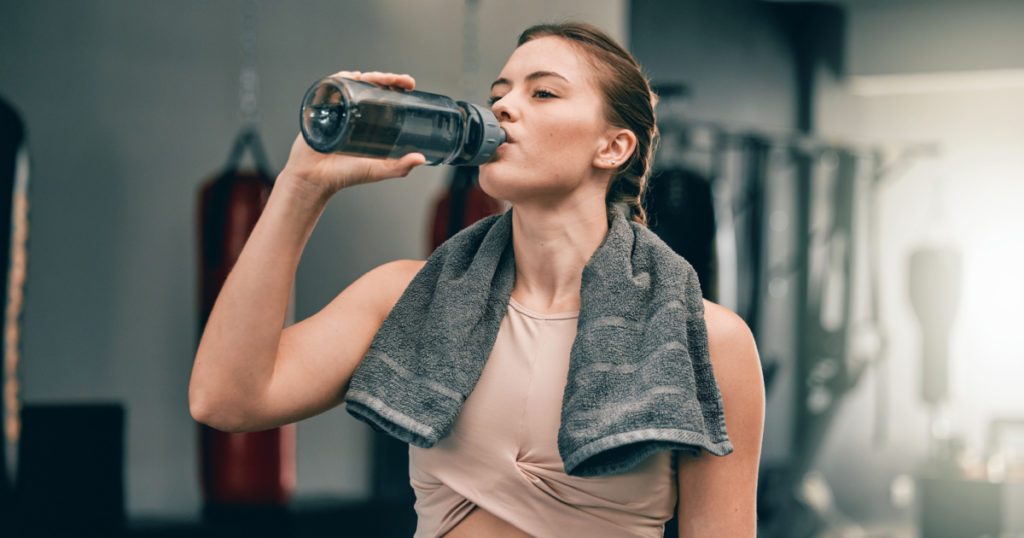 Exercise health, gym and woman drinking water for sports thirst hydration, fitness performance or running workout. Athlete wellness, fatigue and tired girl with liquid bottle drink after training
