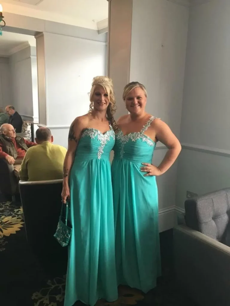 Two women wearing matching dresses