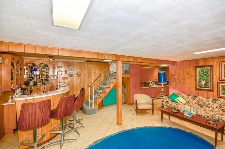 The basement was transformed into a relaxation room where one could sit at the bar, play some poker, or warm up by the fireplace.