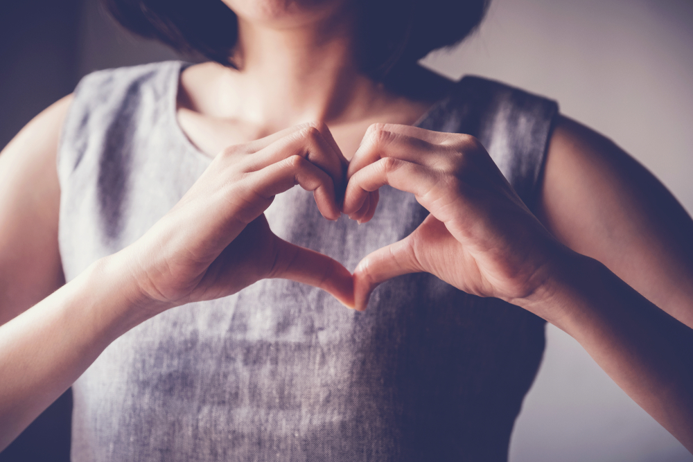 Woman making hands in heart shape, heart health insurance,social responsibility, gratitude,donation, happy charity volunteer, world heart day, appreciation concept, world mental health day
