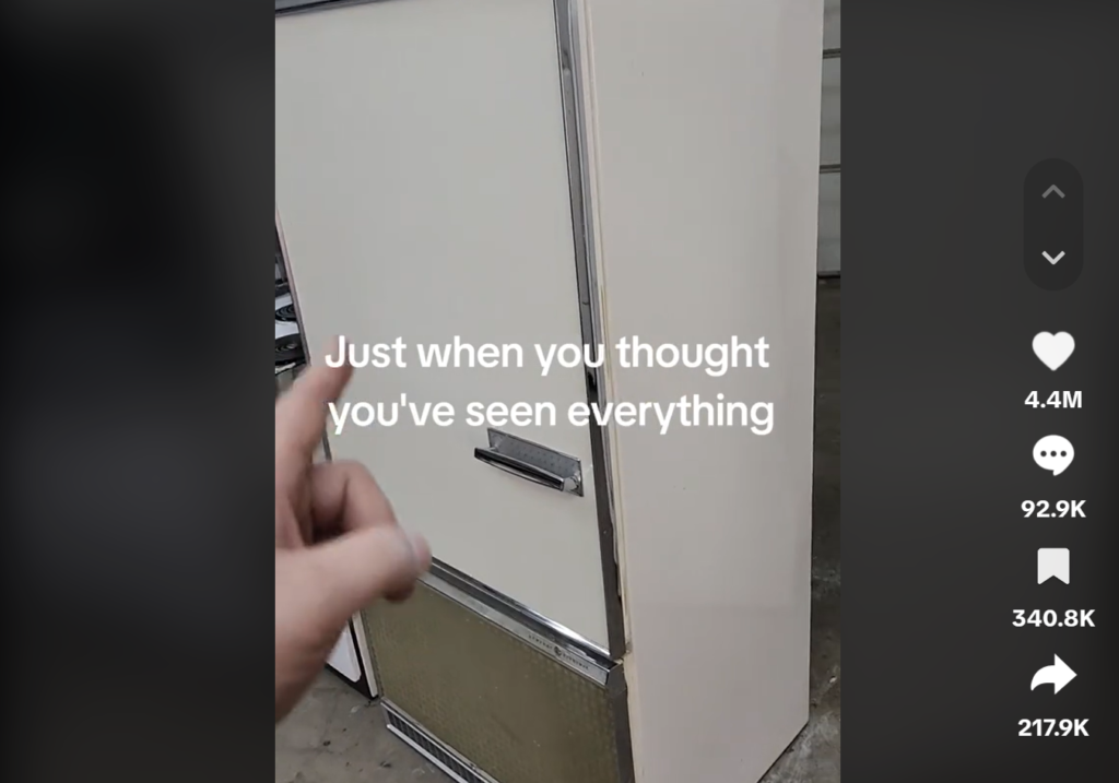 hand pointing to a fridge door