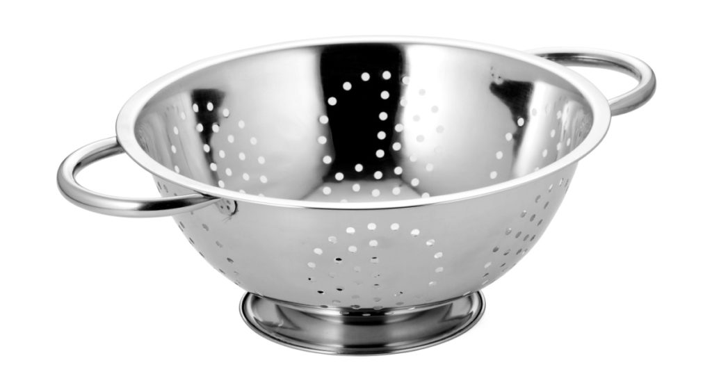 Stainless steel colander on white background