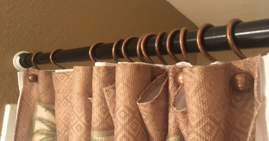 Close Up of Shower Curtain Rings Hanging on Shower Curtain Rod