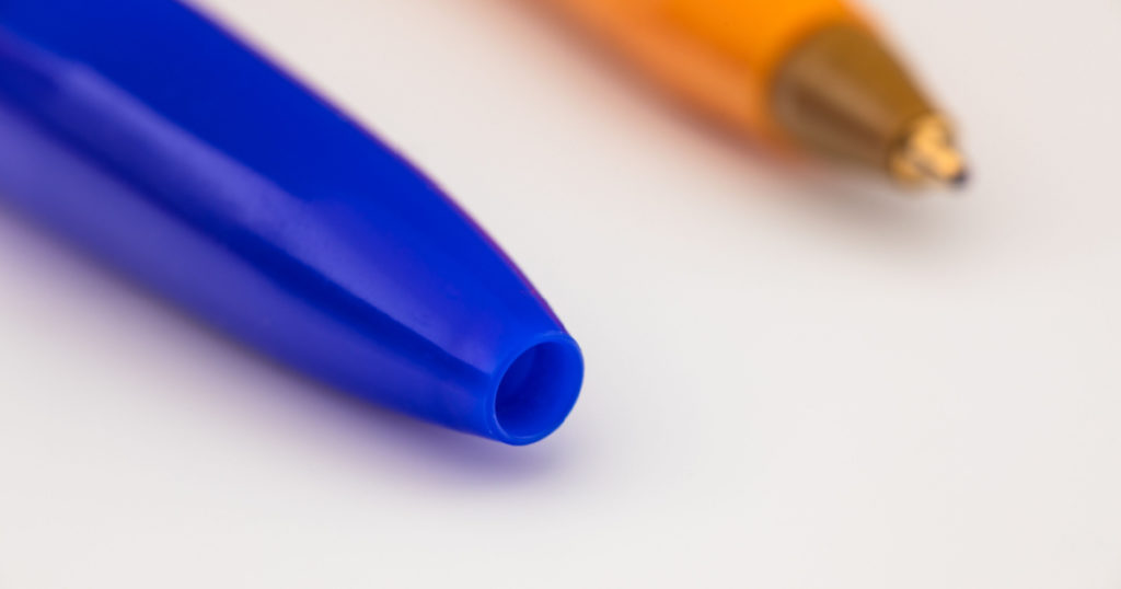 Pen caps have a small hole to prevent choking if swallowed and to equalize the pressure inside the pen to keep it from leaking.