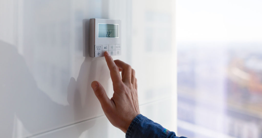 The air conditioning and heating control panel for the apartment and office is located on a white wall
