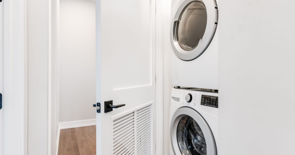 Stackable White Front Load Washer and Dryer in White Closet