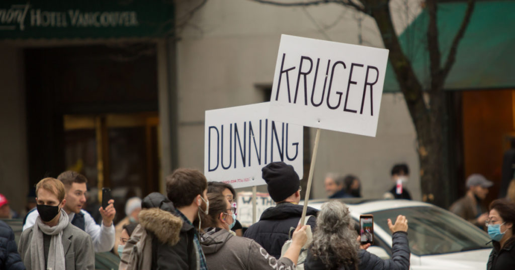 Vancouver, BC, Canada, February 5, 2022, The crowd of Canadians in the Burrard street with the signs KRUGER DUNNING in downtown