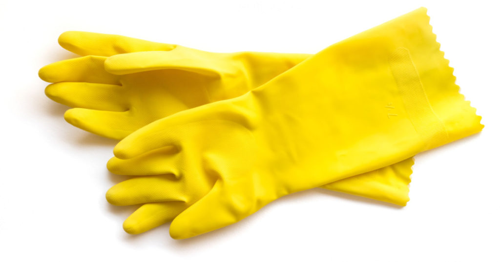 Yellow rubber gloves for cleaning on white background, workhouse concept