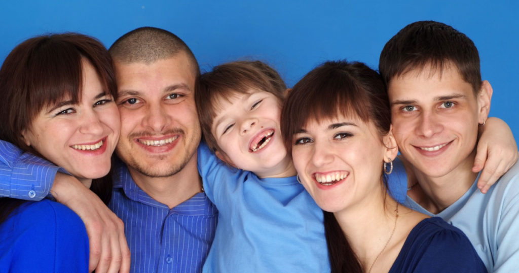 A happy family of five on a blue background