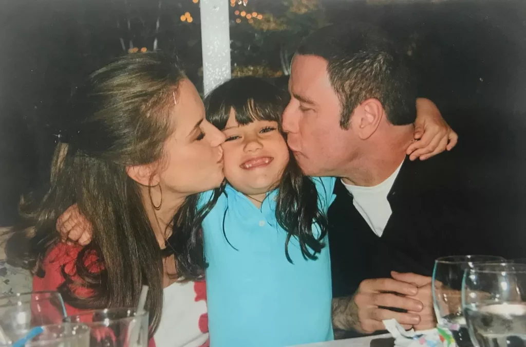 Ella Bleu Travolta being kissed by her parents