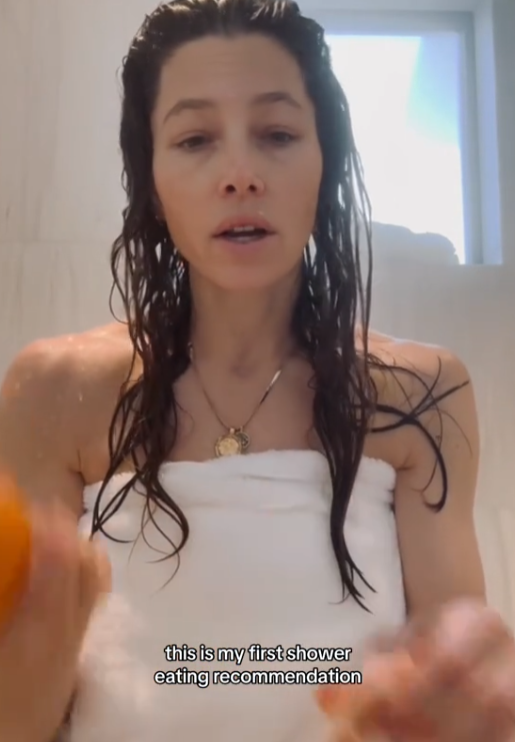 Jessica Biel in the shower eating an orange