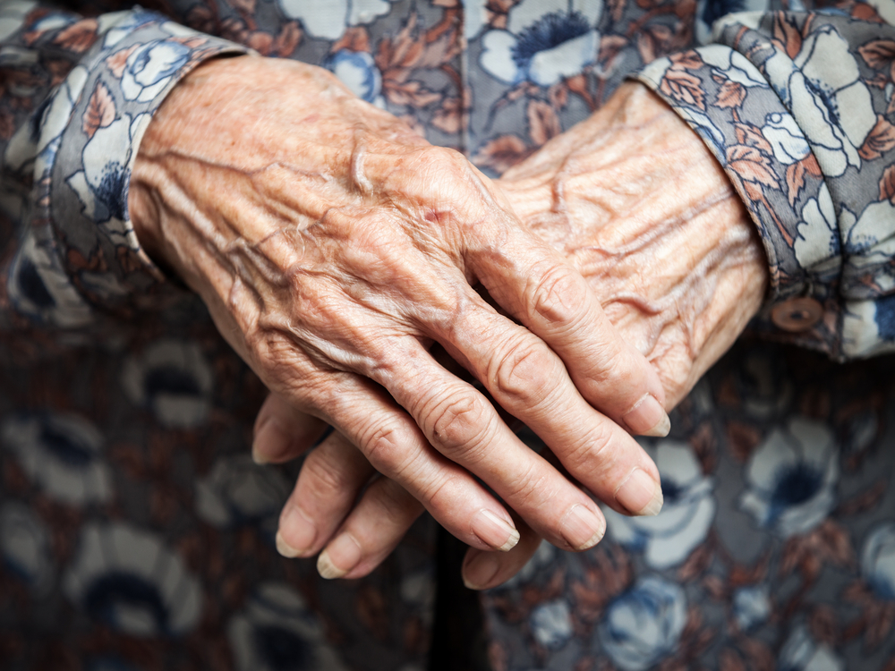 Aging process - very old senior woman hands wrinkled skin