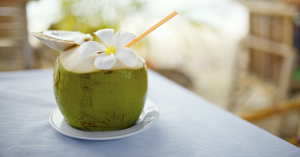coconut drink, served in green coconut shell. Symbolic of tropical vacation.