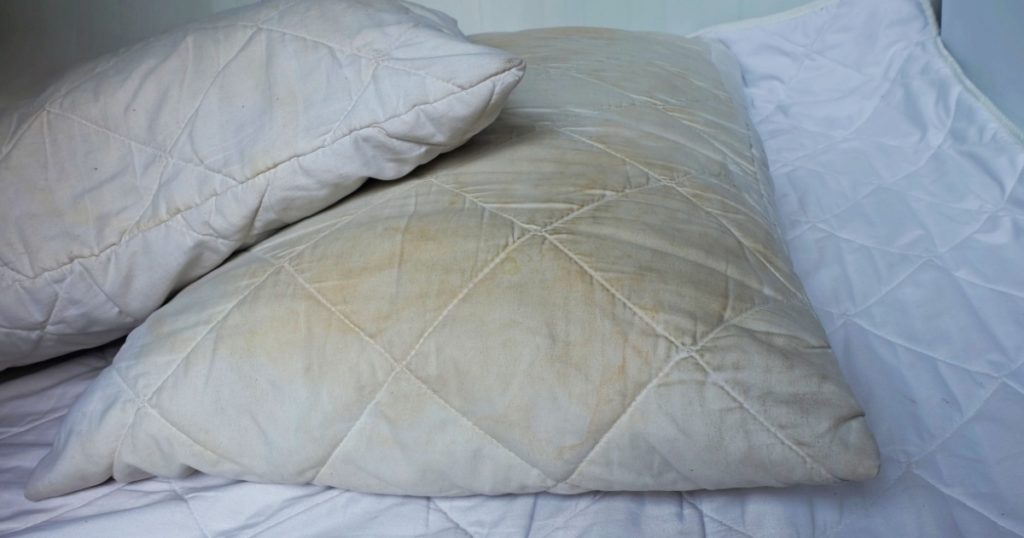 Dirty pillows on white beds are a source of germs and dust mites and mattresses.